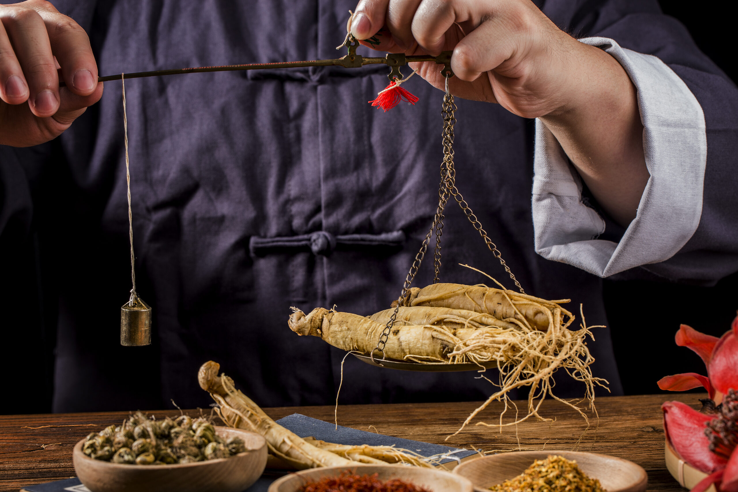 A Chinese medicine practitioner is selecting ginseng, traditiona